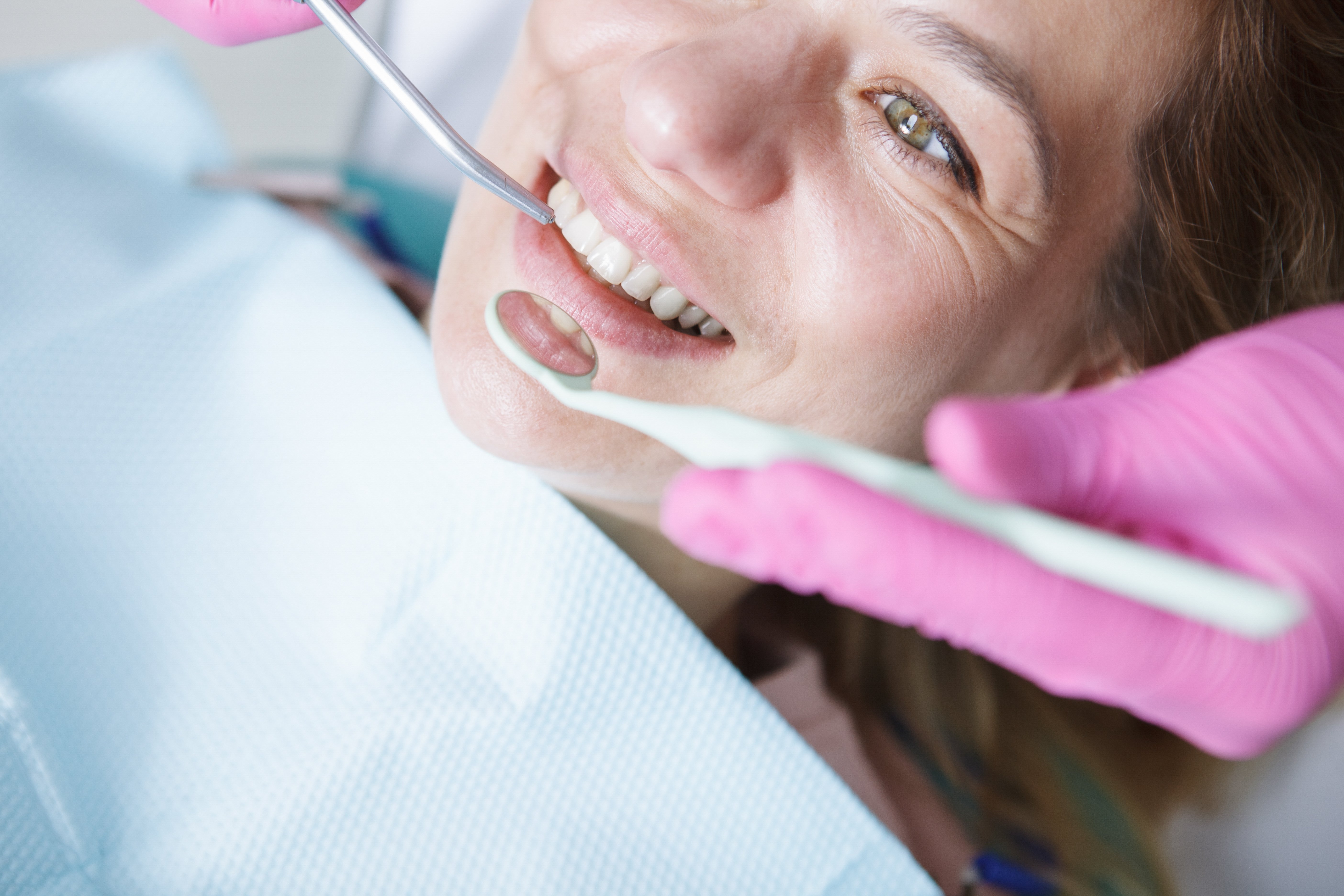 Woman-getting-teeth-checkup-1068475